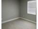 Cozy bedroom featuring tile floor, neutral wall color, and window with blinds at 1256 S Bumby Ave, Orlando, FL 32806