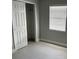 Bedroom featuring tiled floors, a closet and a window for natural light at 1256 S Bumby Ave, Orlando, FL 32806