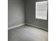 Bedroom featuring tile floor, neutral wall color, and window with blinds at 1256 S Bumby Ave, Orlando, FL 32806