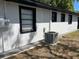 The exterior of a home showcasing newly renovated stucco and black trim at 1256 S Bumby Ave, Orlando, FL 32806