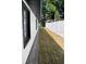 Long narrow side-yard featuring a new white vinyl fence running the length of the property at 1256 S Bumby Ave, Orlando, FL 32806