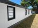 Newly renovated exterior with a brick foundation and freshly painted white stucco at 1256 S Bumby Ave, Orlando, FL 32806