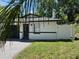 Charming single-story home with a dark garage door and brick-paved driveway and manicured lawn at 1256 S Bumby Ave, Orlando, FL 32806