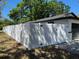 New white vinyl fence provides ample privacy around the entire perimeter of the house at 1256 S Bumby Ave, Orlando, FL 32806
