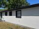 The exterior of a newly renovated stucco home with a new air conditioner at 1256 S Bumby Ave, Orlando, FL 32806