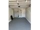 A spacious garage with epoxy flooring and a new garage door at 1256 S Bumby Ave, Orlando, FL 32806