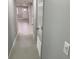 Hallway with tile floor and neutral wall color with white door and trim at 1256 S Bumby Ave, Orlando, FL 32806