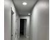 Neutral hallway with two access doors and tiled floors with recessed ceiling lights at 1256 S Bumby Ave, Orlando, FL 32806