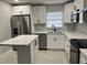 Well lit kitchen featuring white cabinets, stainless steel appliances, and a kitchen island at 1256 S Bumby Ave, Orlando, FL 32806