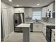 Updated kitchen with white cabinets, stainless steel appliances, and a kitchen island at 1256 S Bumby Ave, Orlando, FL 32806