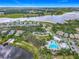 Community aerial shot with a stunning lake view, green landscapes, swimming pool, and surrounding homes at 1373 Williams Rd, Winter Garden, FL 34787