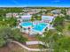 Overhead view showcasing community pools, lush landscaping, and vibrant homes in a well-maintained neighborhood at 1373 Williams Rd, Winter Garden, FL 34787