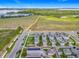 Aerial view of new homes near lake and fields, featuring solar panels and charming streets at 1373 Williams Rd, Winter Garden, FL 34787