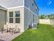Backyard with paver patio, chairs, and well-manicured grass along a fence with some small trees at 1373 Williams Rd, Winter Garden, FL 34787