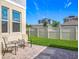 Paver patio in the backyard features two chairs with side table and a well maintained green lawn at 1373 Williams Rd, Winter Garden, FL 34787