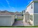 Exterior view of home with a backyard paver patio, exterior lights, grill, privacy fence, and green space at 1373 Williams Rd, Winter Garden, FL 34787