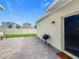 Backyard paver patio with grill and well-maintained lawn with a privacy fence leading to the adjacent house at 1373 Williams Rd, Winter Garden, FL 34787