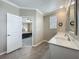 Bright bathroom with double vanity, quartz countertop, and a view into the bedroom at 1373 Williams Rd, Winter Garden, FL 34787