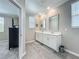 Bathroom featuring double sinks with framed mirrors, and a gray hexagon tiled floor at 1373 Williams Rd, Winter Garden, FL 34787