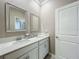 Bright bathroom featuring double sinks, a quartz countertop, and modern white cabinetry at 1373 Williams Rd, Winter Garden, FL 34787
