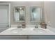 Well-lit bathroom features a double vanity with pristine sinks, modern faucets, and elegant mirrors for a luxurious feel at 1373 Williams Rd, Winter Garden, FL 34787