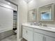 Bathroom with double sink vanity, white cabinets, and tub-shower combo at 1373 Williams Rd, Winter Garden, FL 34787