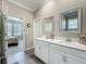 Elegant bathroom with double vanity sinks, quartz countertop, modern mirrors, and a view into the bedroom at 1373 Williams Rd, Winter Garden, FL 34787