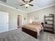 Bright bedroom with plush carpeting, a queen bed, and a decorative shelf, creating a relaxing retreat at 1373 Williams Rd, Winter Garden, FL 34787