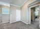 Neutral bedroom with a window, a doorway to the walk-in closet, and light-colored carpeting at 1373 Williams Rd, Winter Garden, FL 34787