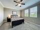 Cozy bedroom with patterned bedding, bedside lamps, and multiple windows for natural light at 1373 Williams Rd, Winter Garden, FL 34787