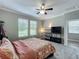 Spacious bedroom featuring a ceiling fan, large windows, and an entertainment center, perfect for relaxing at 1373 Williams Rd, Winter Garden, FL 34787