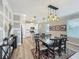A dining area features an adjacent kitchen and hardwood flooring throughout the room at 1373 Williams Rd, Winter Garden, FL 34787