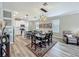 A dining area features an adjacent kitchen and hardwood flooring throughout the room at 1373 Williams Rd, Winter Garden, FL 34787