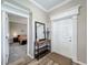 Open foyer showcasing hardwood floors, trim work, and a glimpse into the bedroom creating a warm and inviting space at 1373 Williams Rd, Winter Garden, FL 34787