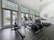Bright fitness center with state-of-the-art exercise equipment and large windows overlooking the community pool at 1373 Williams Rd, Winter Garden, FL 34787