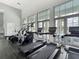 Well-equipped community gym featuring treadmills, ellipticals, and large windows with scenic outdoor views at 1373 Williams Rd, Winter Garden, FL 34787