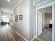 Hallway leading to an open-concept kitchen, dining, and living area, with a view into a carpeted bedroom through a doorway at 1373 Williams Rd, Winter Garden, FL 34787