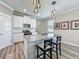 Bright kitchen featuring a large center island with bar seating, stainless appliances, white cabinets, and modern pendant lights at 1373 Williams Rd, Winter Garden, FL 34787