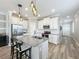 Spacious kitchen island with barstool seating, stainless steel appliances, and white cabinets. Well lit with pendant lights at 1373 Williams Rd, Winter Garden, FL 34787