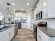 Spacious kitchen featuring stainless steel appliances, white cabinetry, and a convenient center island with barstool seating at 1373 Williams Rd, Winter Garden, FL 34787