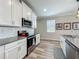 Kitchen with gray counter tops, stainless steel appliances, subway tile back splash and white cabinets at 1373 Williams Rd, Winter Garden, FL 34787