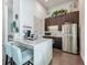 Modern kitchenette with stainless steel refrigerator, dark cabinets, and marble countertops at 1373 Williams Rd, Winter Garden, FL 34787