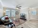 Bright living room features a ceiling fan, hardwood flooring, and a television set at 1373 Williams Rd, Winter Garden, FL 34787