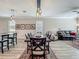 A dining area features an adjacent kitchen and living space with hardwood flooring at 1373 Williams Rd, Winter Garden, FL 34787