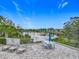 Relaxing patio with a dining table, lounge chairs, and scenic views of the tranquil lake and waterfront homes at 1373 Williams Rd, Winter Garden, FL 34787