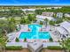 Aerial view of a large community pool with many lounge chairs and a palm tree border at 1373 Williams Rd, Winter Garden, FL 34787
