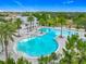 Resort-style community pool with palm trees, sun loungers, and ample seating areas under a clear blue sky at 1373 Williams Rd, Winter Garden, FL 34787