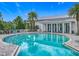 Sparkling community pool with poolside seating and elegant building facade reflecting in the clear turquoise water at 1373 Williams Rd, Winter Garden, FL 34787