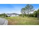 Manicured backyard with lush green lawn, and mature trees, offering a serene and private outdoor space at 1688 Tamarind Rd, Davenport, FL 33896