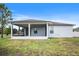 Backyard featuring a screened lanai, well maintained lawn, and exterior view of the house at 1688 Tamarind Rd, Davenport, FL 33896